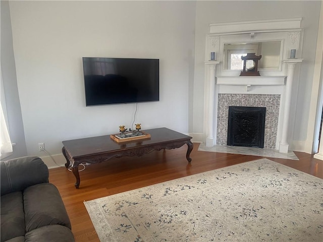 803 W Main St, Clarksville, AR 72830 - living room with wood finished floors, a tile fireplace, and baseboards