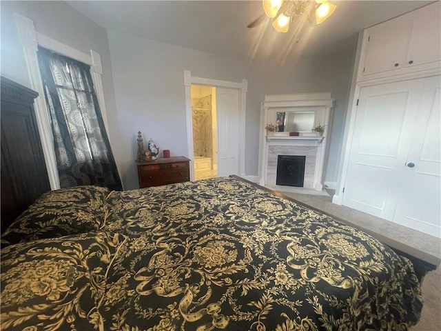 803 W Main St, Clarksville, AR 72830 - bedroom with carpet flooring, a tile fireplace, and connected bathroom