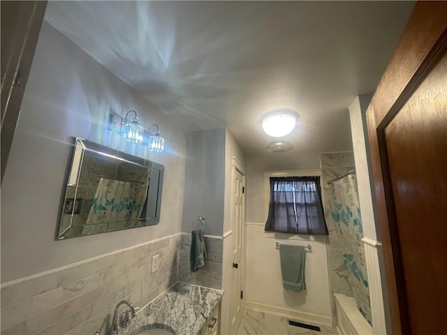 803 W Main St, Clarksville, AR 72830 - bathroom featuring marble finish floors, a shower with curtain, vanity, and a wainscoted wall
