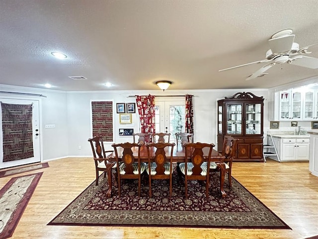 5121 E State Highway 22, Paris, AR 72855 - dining room with light wood finished floors, a textured ceiling, a ceiling fan, ornamental molding, and recessed lighting