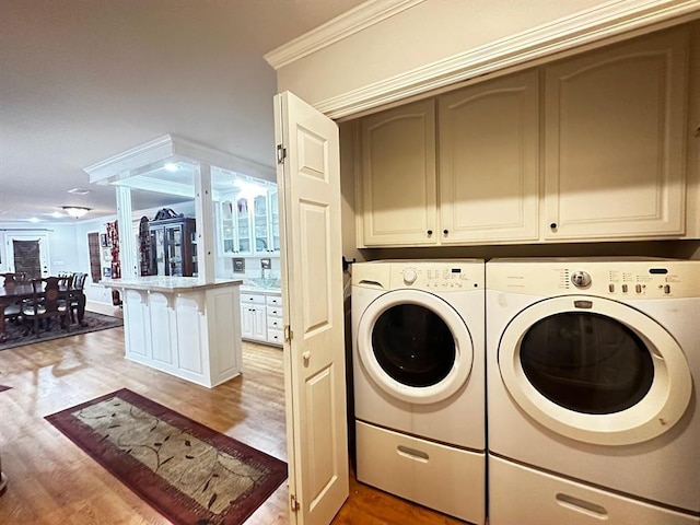 5121 E State Highway 22, Paris, AR 72855 - laundry room featuring washing machine and dryer, light wood-style flooring, and crown molding