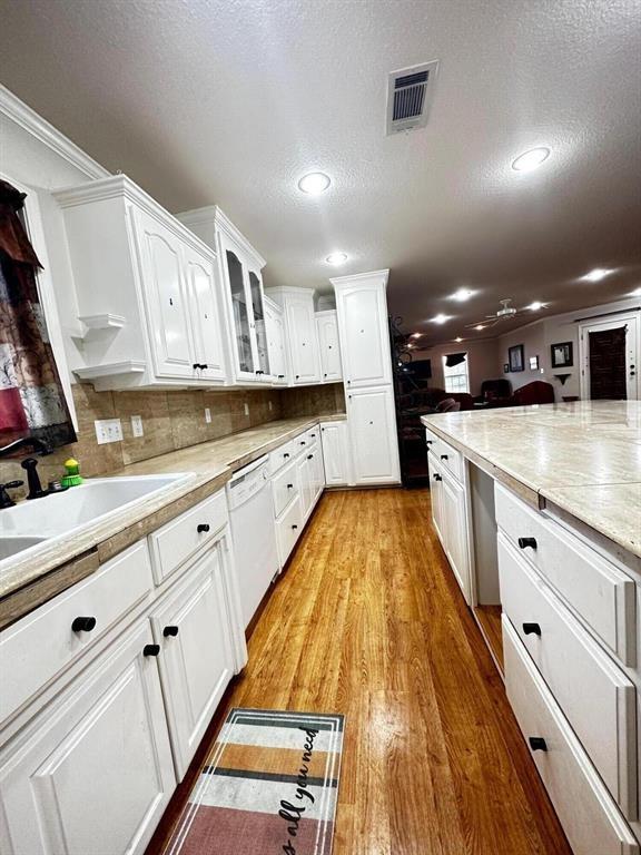 5121 E State Highway 22, Paris, AR 72855 - kitchen featuring dishwasher, white cabinets, light wood-type flooring, recessed lighting, and a textured ceiling