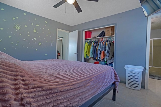 tiled bedroom with a textured ceiling, a closet, and ceiling fan