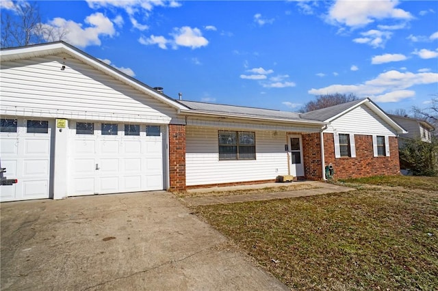 ranch-style home with an attached garage, driveway, and brick siding