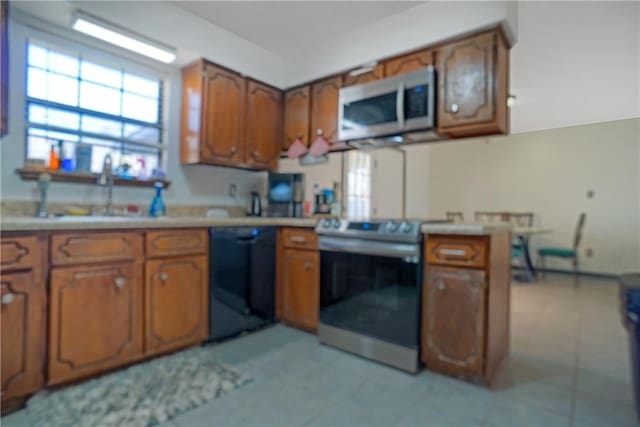 kitchen featuring black dishwasher, a sink, light countertops, brown cabinetry, and electric range