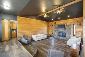 15515 Ar-105, Hector, AR 72843 - living room featuring a stone fireplace, vaulted ceiling with beams, ceiling fan, and wood finished floors