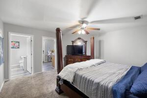 15515 Ar-105, Hector, AR 72843 - carpeted bedroom with visible vents, a ceiling fan, and ensuite bath