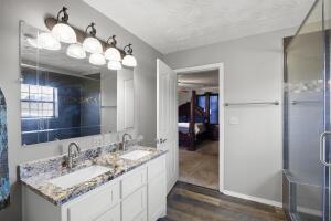 15515 Ar-105, Hector, AR 72843 - full bath featuring an enclosed shower, wood finished floors, double vanity, and a sink
