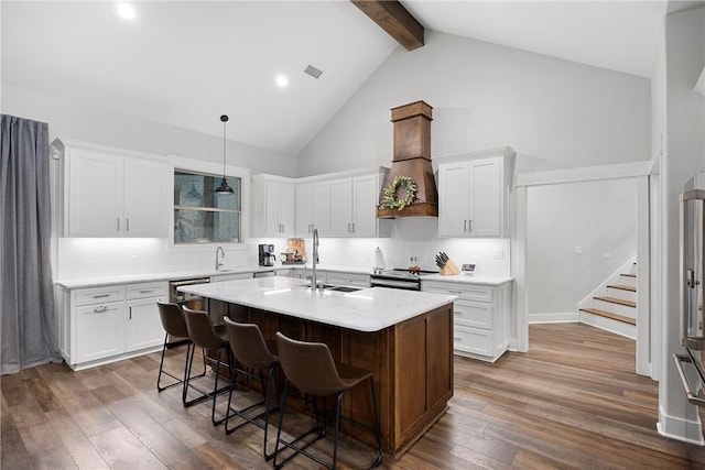251 Kordsmeier Ln, Morrilton, AR 72110 - kitchen featuring beam ceiling, high vaulted ceiling, light countertops, appliances with stainless steel finishes, and an island with sink