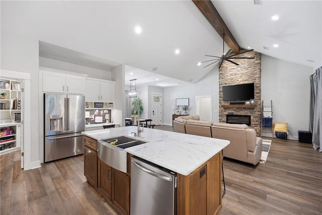 251 Kordsmeier Ln, Morrilton, AR 72110 - kitchen featuring stainless steel appliances, a sink, ceiling fan, a kitchen island with sink, and dark wood-type flooring
