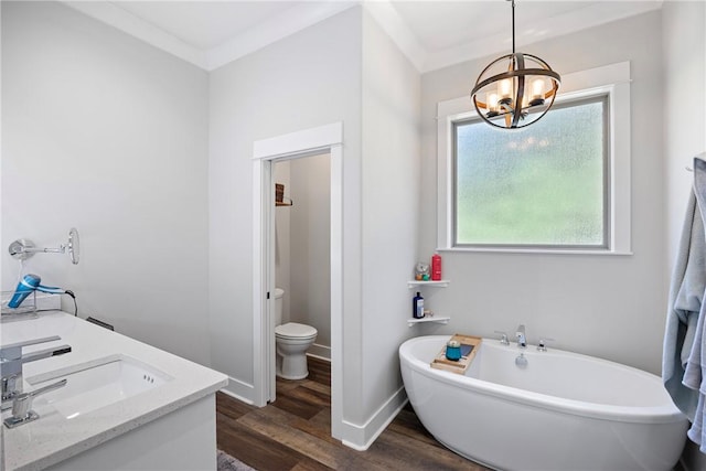 251 Kordsmeier Ln, Morrilton, AR 72110 - full bathroom featuring a freestanding bath, wood finished floors, a chandelier, double vanity, and toilet