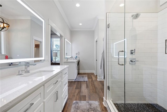251 Kordsmeier Ln, Morrilton, AR 72110 - bathroom with a shower stall, two vanities, wood finished floors, ornamental molding, and baseboards