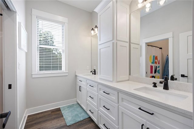 251 Kordsmeier Ln, Morrilton, AR 72110 - full bathroom featuring double vanity, wood finished floors, and baseboards