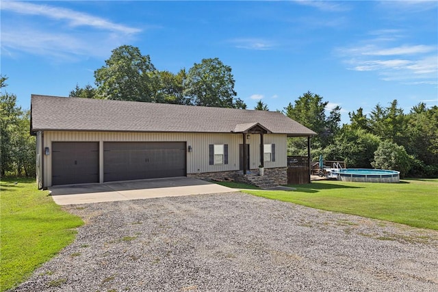 251 Kordsmeier Ln, Morrilton, AR 72110 - view of front of home with driveway, a front yard, an outdoor pool, a garage, and stone siding