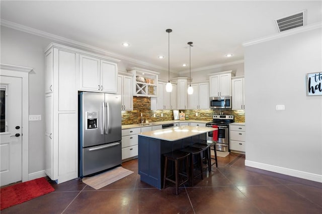 251 Kordsmeier Ln, Morrilton, AR 72110 - kitchen with appliances with stainless steel finishes, baseboards, a kitchen breakfast bar, backsplash, and crown molding