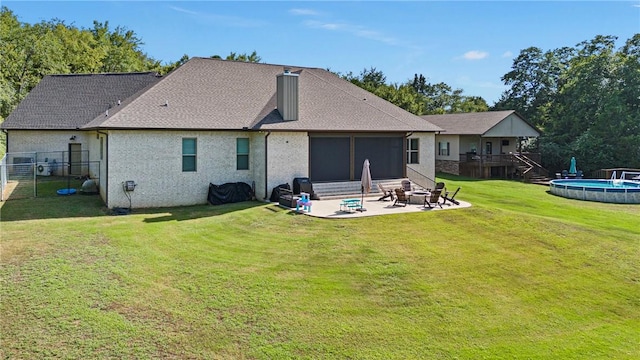 251 Kordsmeier Ln, Morrilton, AR 72110 - rear view of property featuring a fire pit, a patio, an outdoor pool, and a shingled roof