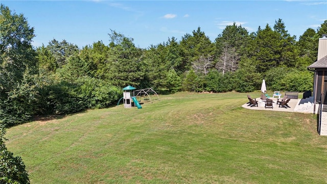 251 Kordsmeier Ln, Morrilton, AR 72110 - view of grassy yard with a patio area, a playground, and an outdoor fire pit