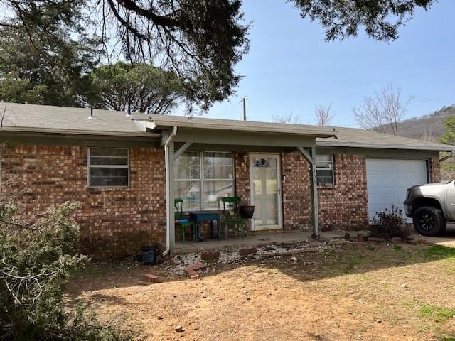 409 NW 8th St, Atkins, AR 72823 - ranch-style home featuring brick siding and an attached garage