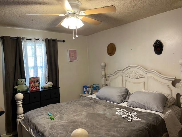 409 NW 8th St, Atkins, AR 72823 - bedroom with a textured ceiling and a ceiling fan