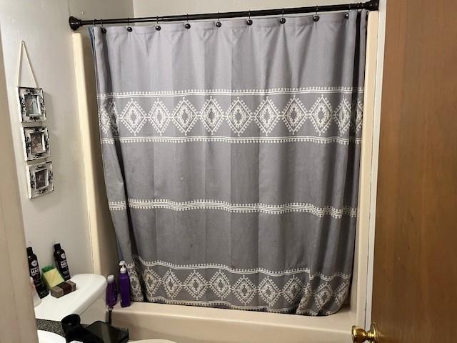 409 NW 8th St, Atkins, AR 72823 - full bathroom with toilet and shower / bathtub combination with curtain