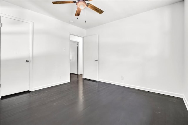 922 Scenic Dr, Perryville, AR 72126 - unfurnished bedroom featuring baseboards, ceiling fan, and dark wood-type flooring