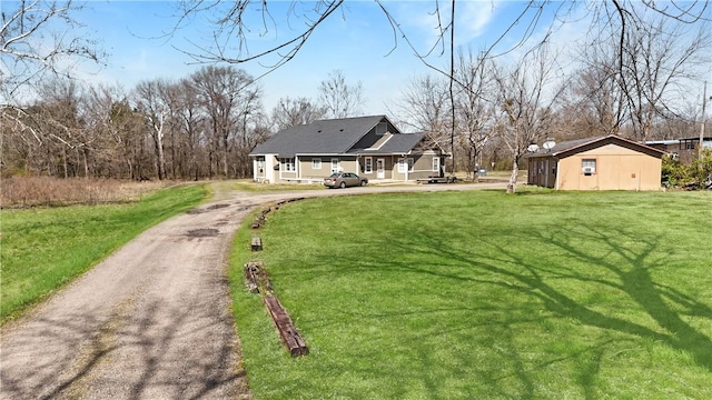 206 Arkansas St, Danville, AR 72833 - back of house with asphalt driveway and a lawn
