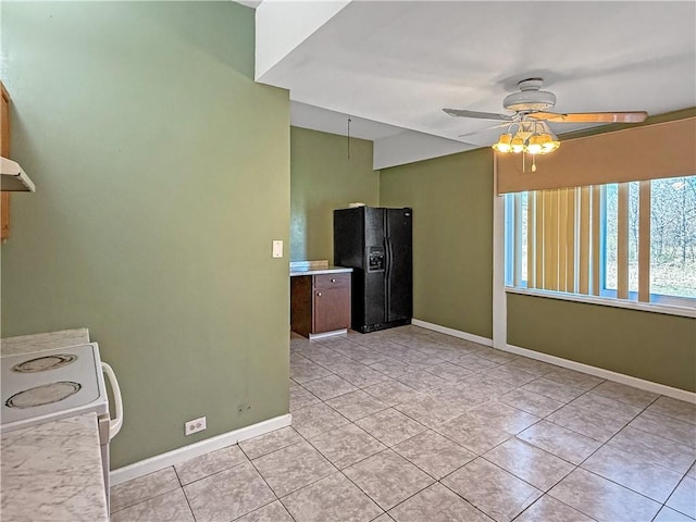 206 Arkansas St, Danville, AR 72833 - kitchen featuring black refrigerator with ice dispenser, ceiling fan, baseboards, light tile patterned flooring, and light countertops