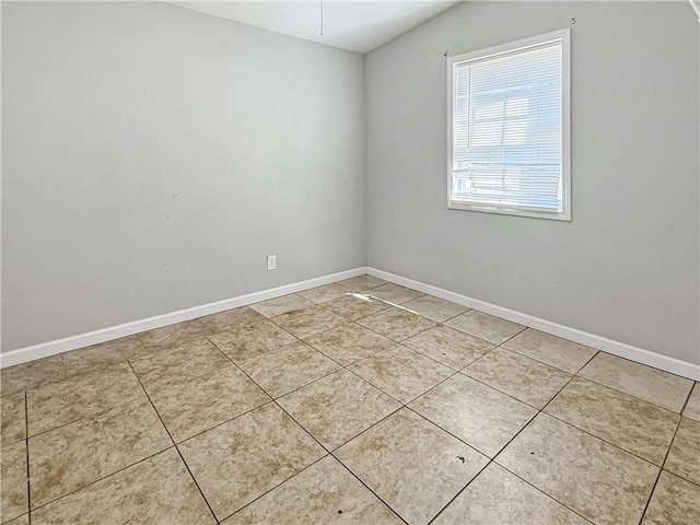 206 Arkansas St, Danville, AR 72833 - unfurnished room featuring vaulted ceiling, light tile patterned flooring, and baseboards