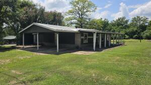 view of outdoor structure featuring an attached carport