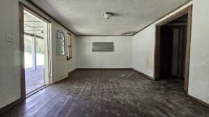 corridor featuring baseboards and a textured ceiling