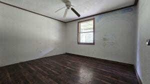unfurnished room featuring wood finished floors and a ceiling fan