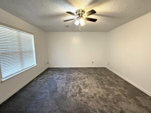 1001 W 17th Ter, Russellville, AR 72801 - carpeted empty room with ceiling fan, baseboards, and a textured ceiling