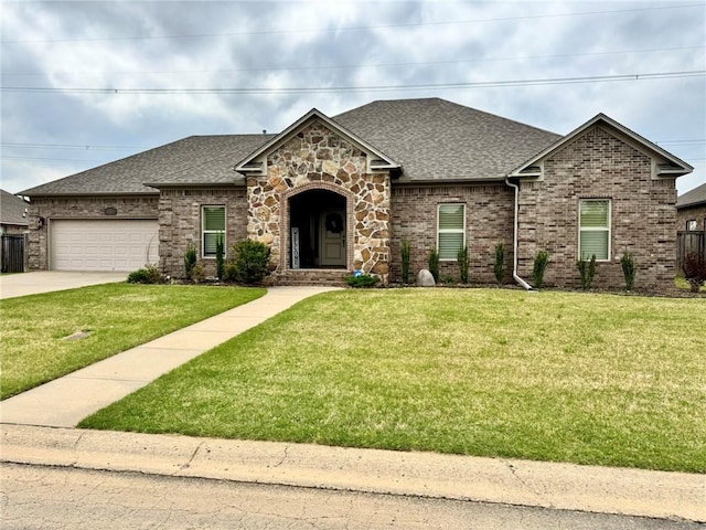 335 Point W, Conway, AR 72034 - view of front of home featuring a garage, driveway, a shingled roof, and a front yard