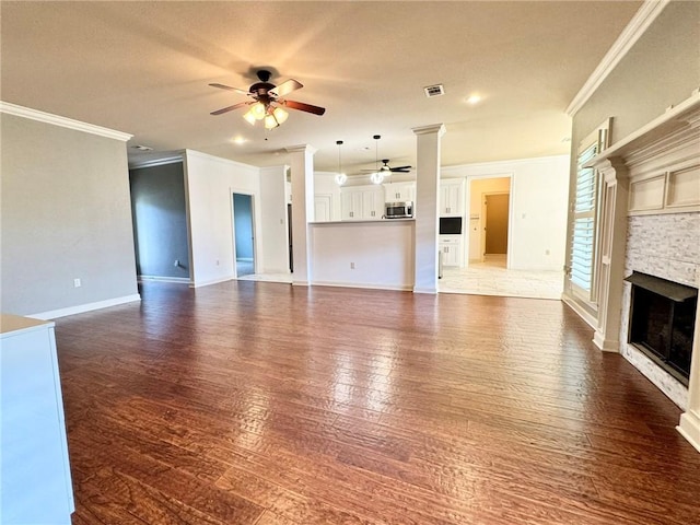 335 Point W, Conway, AR 72034 - unfurnished living room featuring ornamental molding, a ceiling fan, visible vents, and a fireplace