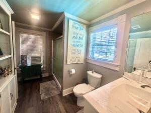 2816 Honeysuckle Ln, Russellville, AR 72801 - full bath featuring wood finished floors, toilet, a stall shower, vanity, and crown molding