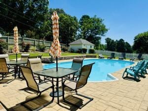 2816 Honeysuckle Ln, Russellville, AR 72801 - outdoor pool with a patio area, fence, and outdoor dining area