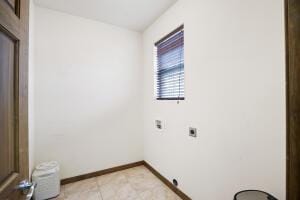 washroom with laundry area, hookup for an electric dryer, and baseboards