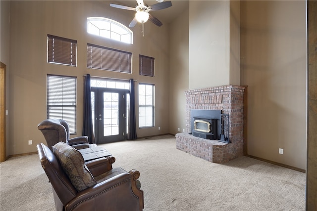 279 Eagle Cove Rd, Lamar, AR 72846 - living area with carpet flooring, ceiling fan, a towering ceiling, plenty of natural light, and a wood stove