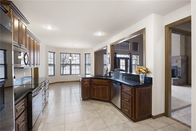 279 Eagle Cove Rd, Lamar, AR 72846 - kitchen featuring stainless steel appliances, a chandelier, light tile patterned floors, a sink, and decorative light fixtures