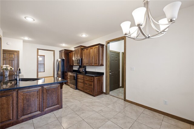 279 Eagle Cove Rd, Lamar, AR 72846 - kitchen featuring stainless steel appliances, dark countertops, a sink, a chandelier, and light tile patterned floors