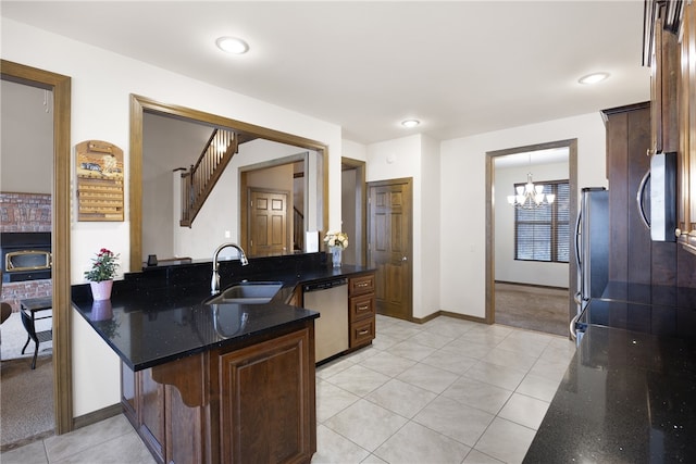279 Eagle Cove Rd, Lamar, AR 72846 - kitchen featuring a sink, stainless steel appliances, a chandelier, light tile patterned floors, and dark stone counters