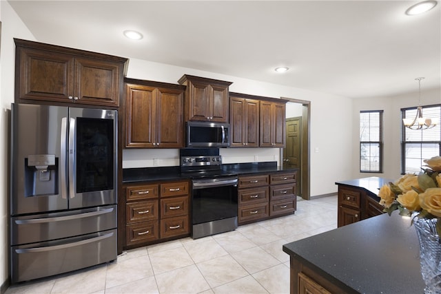 279 Eagle Cove Rd, Lamar, AR 72846 - kitchen featuring appliances with stainless steel finishes, light tile patterned flooring, a chandelier, dark brown cabinets, and dark countertops