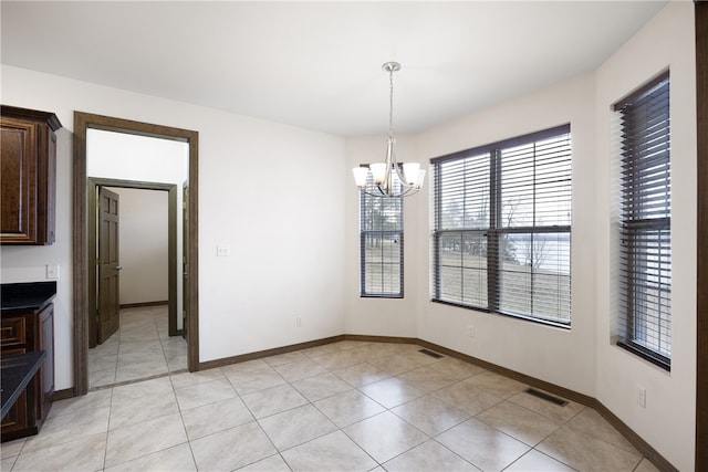 279 Eagle Cove Rd, Lamar, AR 72846 - unfurnished dining area featuring a chandelier, light tile patterned floors, and baseboards