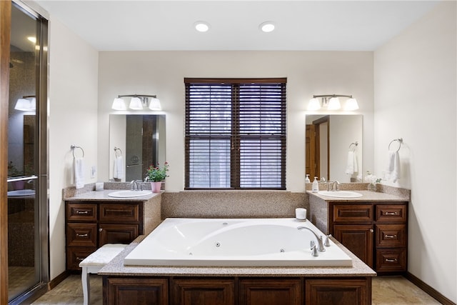 279 Eagle Cove Rd, Lamar, AR 72846 - full bathroom with a jetted tub, two vanities, a shower stall, and recessed lighting
