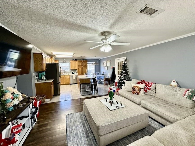 6011 River Rd, Pottsville, AR 72858 - living room with ceiling fan, a textured ceiling, light wood finished floors, and ornamental molding
