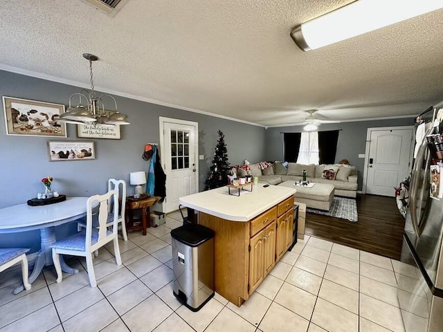 6011 River Rd, Pottsville, AR 72858 - kitchen with crown molding, light countertops, light tile patterned floors, a textured ceiling, and ceiling fan