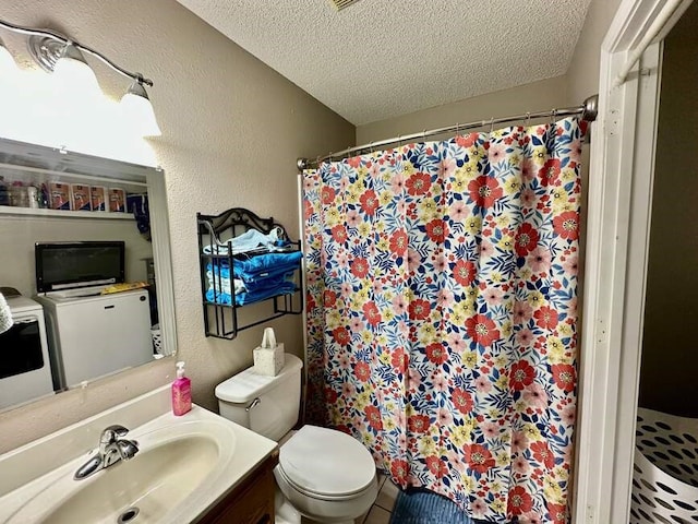 6011 River Rd, Pottsville, AR 72858 - bathroom with independent washer and dryer, a textured ceiling, a textured wall, toilet, and vanity
