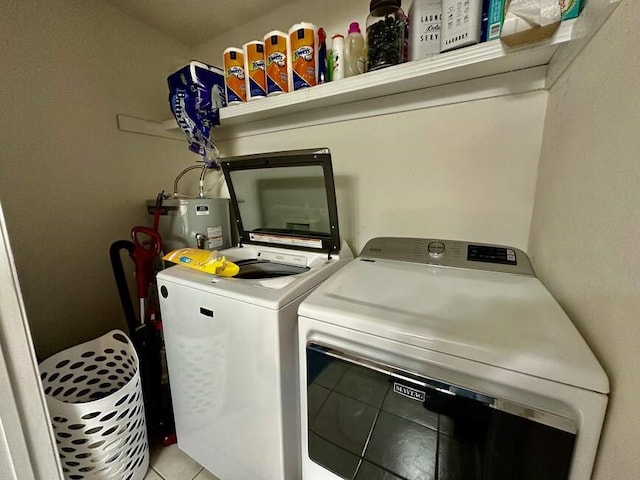6011 River Rd, Pottsville, AR 72858 - clothes washing area featuring water heater, tile patterned flooring, and washer and clothes dryer