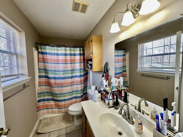 6011 River Rd, Pottsville, AR 72858 - full bath with tile patterned flooring, a textured ceiling, plenty of natural light, vanity, and toilet