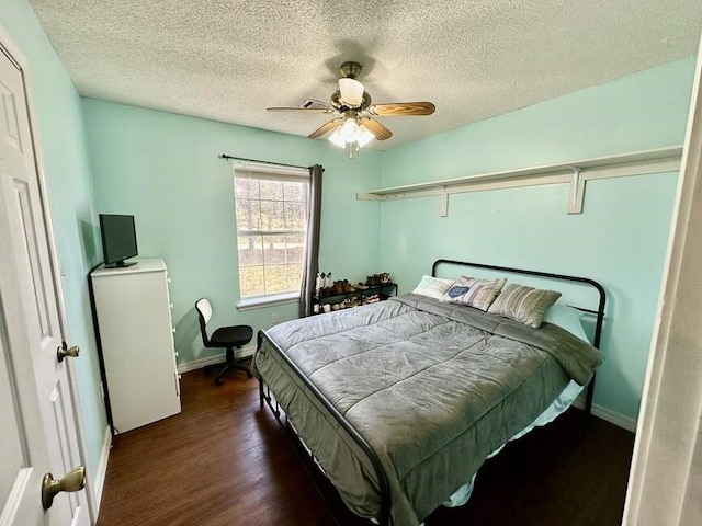 6011 River Rd, Pottsville, AR 72858 - bedroom featuring wood finished floors, a textured ceiling, a ceiling fan, and baseboards